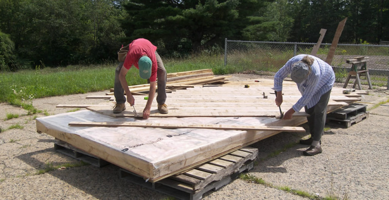 Lloyd and David laying the tongue-and-groove subfloor on August 1